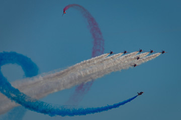 Jet planes fly in formation with colored smoke trails