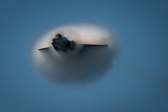 Jet breaks through vapor cone, flying at speed