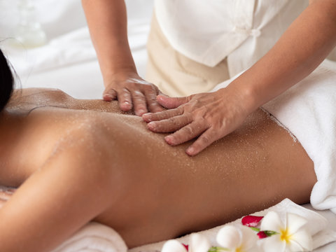 Show Hands moving blur of masseuse while body scrub. Salt Scrub Beauty Treatment in the Health Spa.