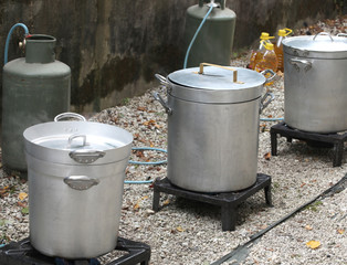 three big cauldrons and the gas cylinders at camp site