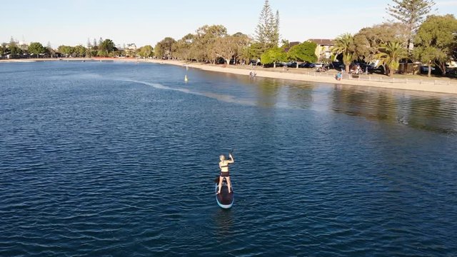aerial view of a female stand up paddle boarder on a river in Australia Gold Coast SUP