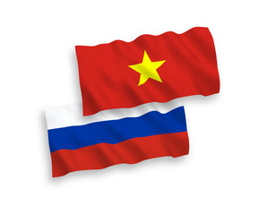 Fototapeta premium National vector fabric wave flags of Vietnam and Russia isolated on white background. 1 to 2 proportion.