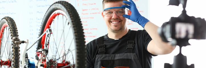 Handsome blogger service man bicycle workshop repair portrait