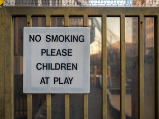 No smoking please, children at play sign posted in recreational playground area