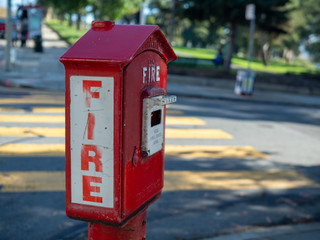 Fototapeta na wymiar Outdoor fire alarm call box at urban intersection