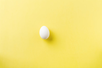 White raw chicken eggs lying on light concrete background. Top view.