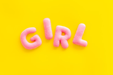 Naklejka premium Girl word as decoration for baby shower on yellow background top view