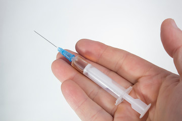 Medical syringe in hand