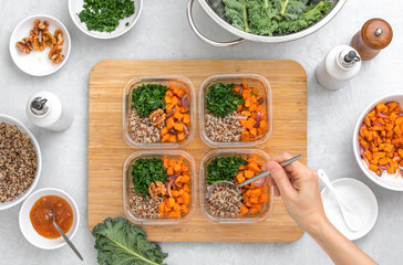Preparing healthy vegetarian food ahead in lunch boxes, top down view