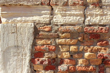 Vintage red and white crumbling brick wall