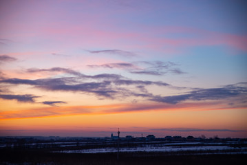 view of winter sunset over snowed field
