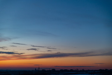 view of winter sunset over snowed field