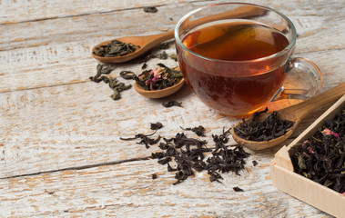 various types of tea on a wooden background