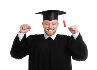 Happy student wearing graduation hat on white background