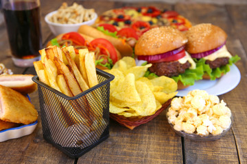 Fast food on old wooden background. Concept of junk eating.