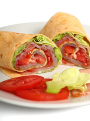 Wrap tortilla sandwich with ham, tomato, lettuce.