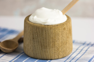 Greek yogurt in wooden pot
