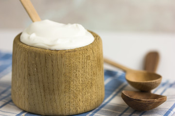 Greek yogurt in wooden pot