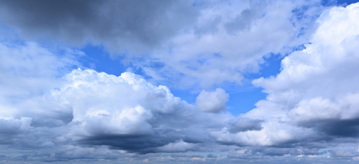 Summer cloudy sky. Horizon, moisture-bearing and vapor-forming atmospheric phenomenon, panoramic image.