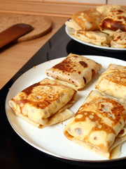 Frying pancakes with fillings. Traditional russian pancakes (blini) with curd. Cheese blintzes.