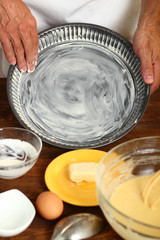 Making Sour Cream Lemon Cake. Preparing Cake Pans For Baking. Greasing with margarine or butter.