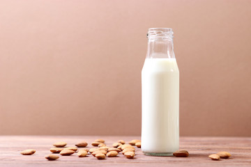 Almond milk and almonds on the table. Vegetable milk. Vegetarian milk.