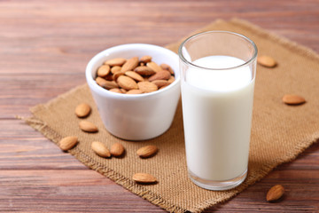 Almond milk and almonds on the table. Vegetable milk. Vegetarian milk.