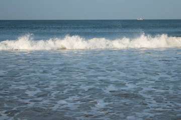 View of the blue sea or ocean with foam and waves background in Gokarna, India