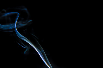 Smoke trail from candles lit from the side