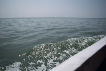 Trail on water sea surface of fast moving boat