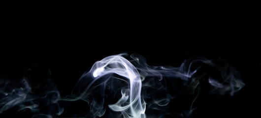 Smoke trail from candles lit from the side © James