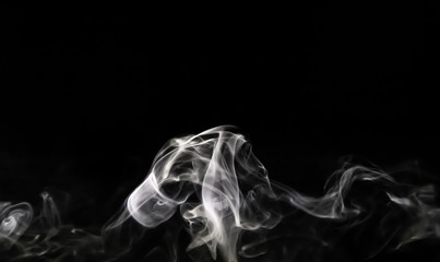 Fototapeta premium Smoke trail from candles lit from the side