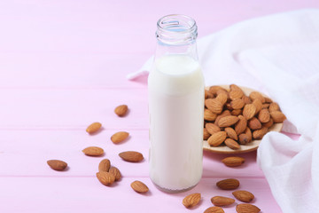 Almond milk and almonds on the table. Vegetable milk. Vegetarian milk.
