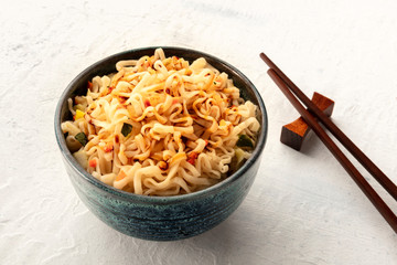 Instant soba noodles with carrot, scallions, and a sauce, a close-up shot with chopsticks and a place for text