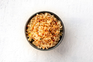Instant soba noodles with carrot, scallions, and a sauce, shot from above with a place for text