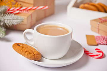 Cup of tea, candy cane, Christmas gift boxes, cookies on the white background