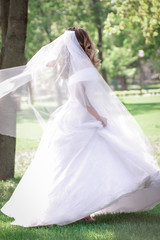 Happy bride in a wedding dress, against the backdrop of beautiful nature. Wedding day