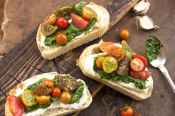Appetizing bruschetta.Traditional italian bruschetta.Open sandwich with source pesto and tomato