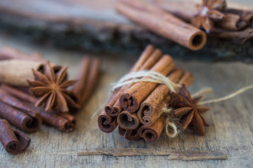 Heap of cinnamon sticks and ground cinnamon with dust effect. Aromatic spice.