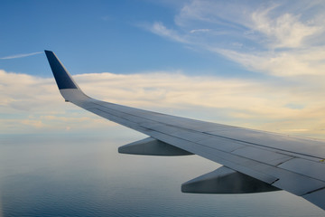 wing of an airplane flying above the clouds