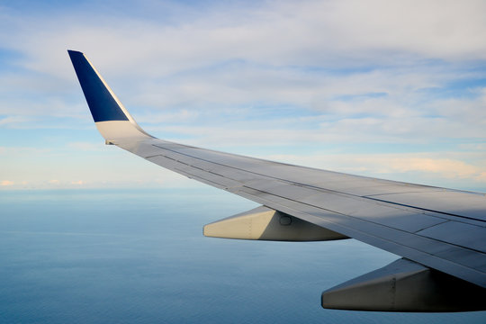 wing of an airplane flying above clouds