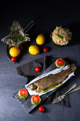 baked trout with herb filling and tomatoes