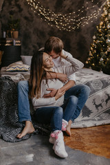 Naklejka premium Romantic couple in love feeling happiness about their romance spending christmas eve together- Image