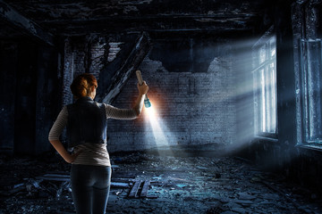 Young woman holding a flashlight - obrazy, fototapety, plakaty