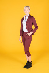 Portrait of confidence caucasian business woman on yellow background