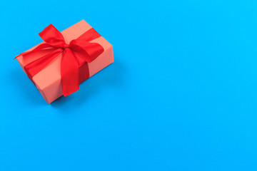 Gift box with ribbon and bow on color background and space for text. Top view - Image