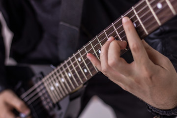 Close-up of musician playing electric guitar.
