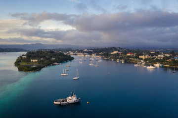 Fototapeta premium Nightfall over the Port Vila harbor with sailboat and other yachts in Vanuatu capital city