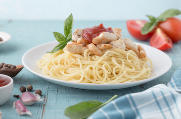 Chicken and Vegetables Pasta. Spaghetti pasta with grilled chicken meat, vegetables and basil, top view, copy space. Seasonal pasta primavera recipe.