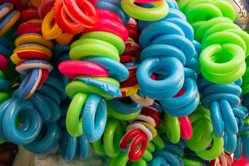 Group of colorful plastic life buoys tied together. Country of Cento, Italy, during the Carnival event to be presented to the public.